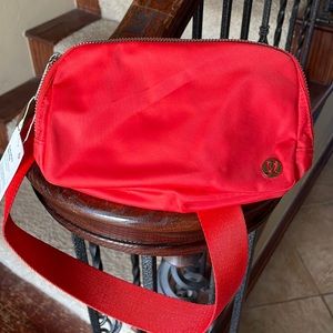 New with tags orange Lululemon Everywhere belt bag.